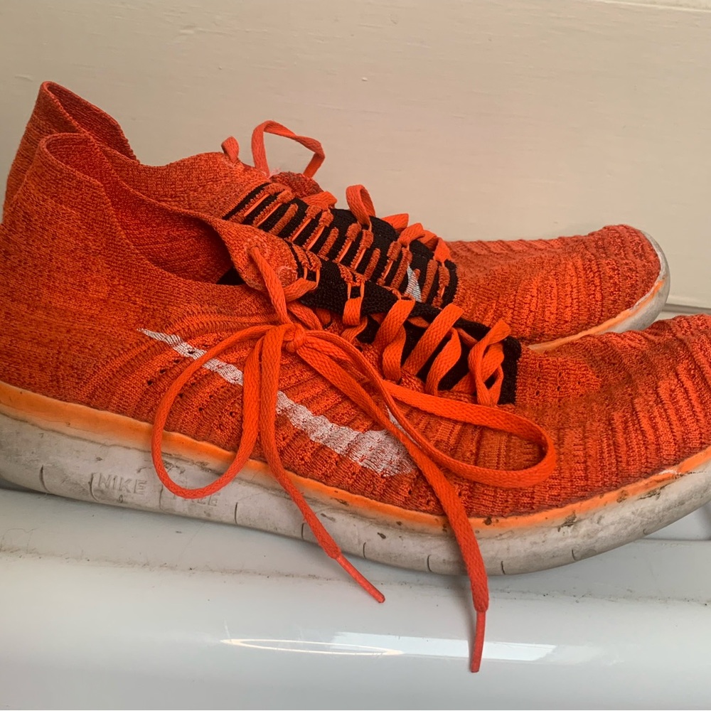 Size 11.5 Nike Flyknit trainers in orange